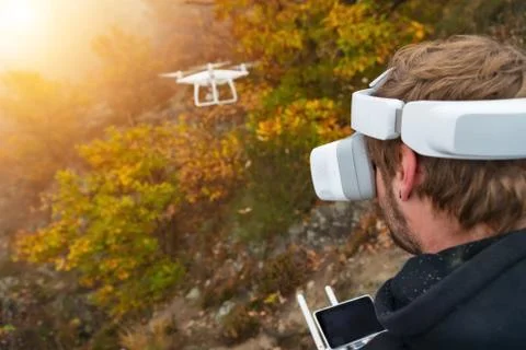 Young man handling drone, using virtual reality glasses. Stock Photos