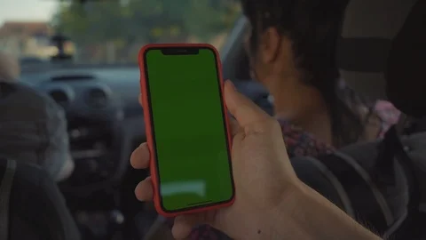Young man hands use smartphone with vertical green screen in car background Stock Footage 116997606
