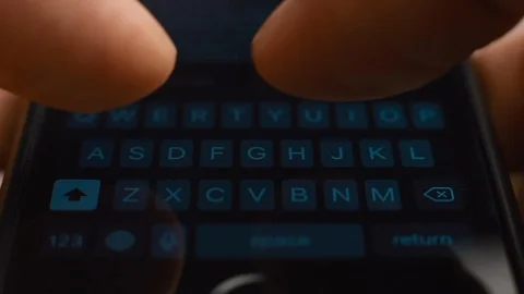 Young man hands using a black touchpad keyboard of smartphone for texting Stock Footage 128369474
