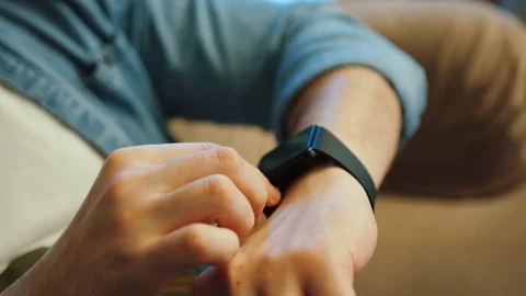 Young man hands using smart watch at home. Close up shot. Video stock 77289277