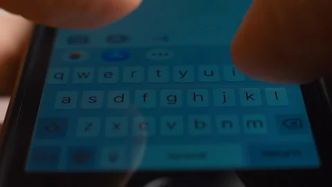 Young man hands using a white touchpad keyboard of smartphone for texting Stock Footage 128369229