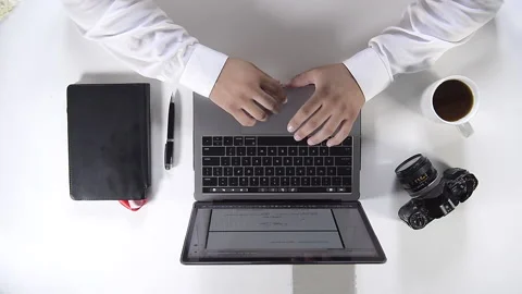 Young man hands working on his laptop, overhead view - Man working at home on Stock Footage 163899366