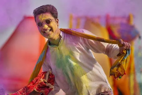 A young man happily dancing during holi celebrations Stock Photos