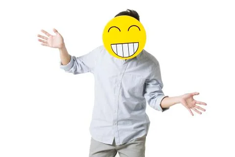 Young man with a happy emoticon face in front of his face Stock Photos