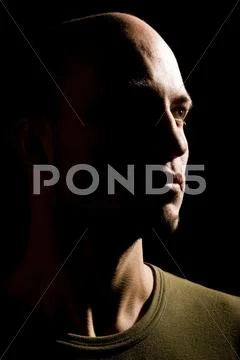Young man in hard side light, portrait Stock Photos
