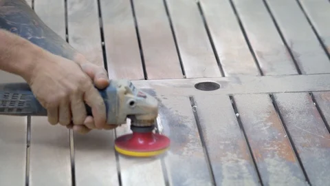 A young man hardworking carpenter plane a plank with a planer. Video stock 88435014