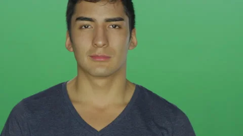 Young man has a blank face, on a green screen background Stock Footage 59982246