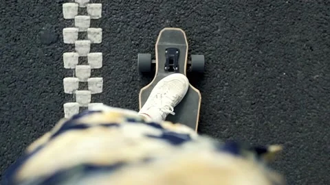 Young man has fun, rides on longboard in middle of empty road . Stockbeeldmateriaal 238626126