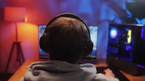 Young man has a video game stream or podcast in neon room. Male gamer playing Stock Footage 270019874