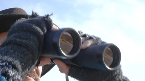 Young man in hat with binocular Stock Footage 86926857