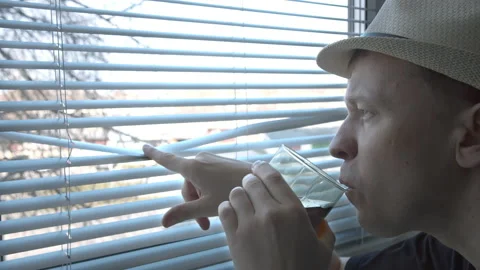 A young man in a hat with interest examines what is happening on the street Stock Footage 157352954