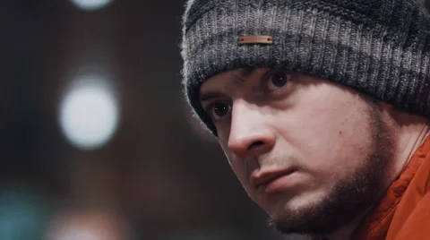 Young man in hat looking at camera outdoor Stock Footage 61865451