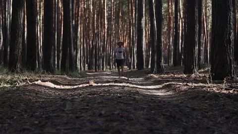 Young man in a hat while hiking in the woods. Narrow focus. Stock Footage 150260878