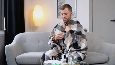 Young man have a fever checking thermometer and measure body temperature. Sick Stock Footage 210894739