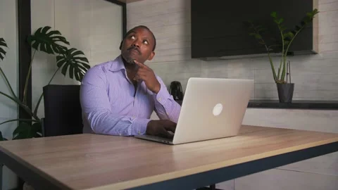 Young man have idea. African Business man working on laptop computer at home Stock Footage 201292629
