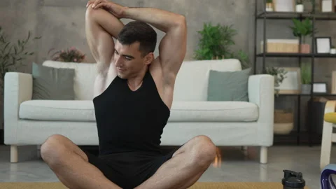 Young man have online training on laptop at home exercise, stretch Stock Footage 278333153