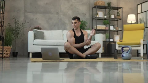 Young man have online training on laptop at home exercise, stretch Stock Footage 278333154