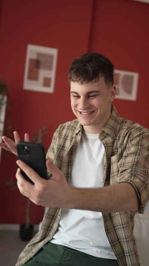 Young man have video call on cellphone or social media direct at home Stock-Footage 303587740