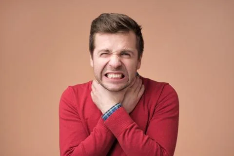 Young man having asthma attack or choking can not breath suffering from respi Stock Photos