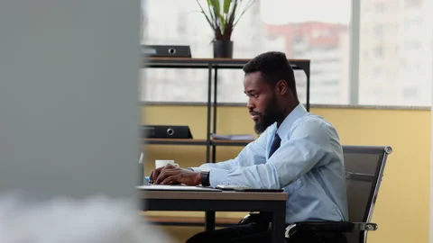Young man having break and working with laptop while sitting at table in modern Stock Footage 169020038