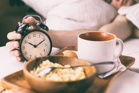 Young man having Breakfast in bed in the morning. Stock Photos