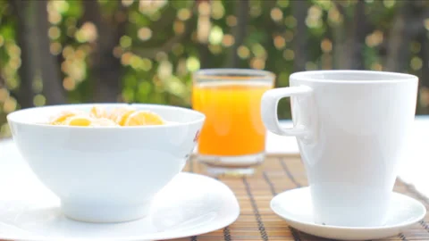 A young man having a breakfast with coffee, cereal, fruits and juice in a b.. Stock Footage 233477395
