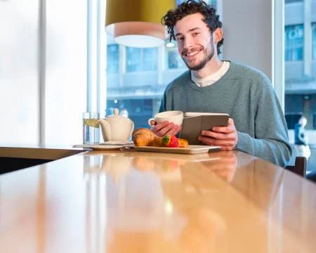 Young man having breakfast Fotos Stock