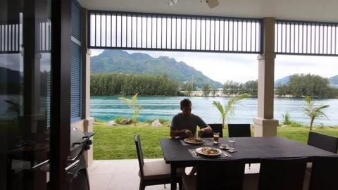 A young man is having breakfast on the terrace. Stock Footage 101770363