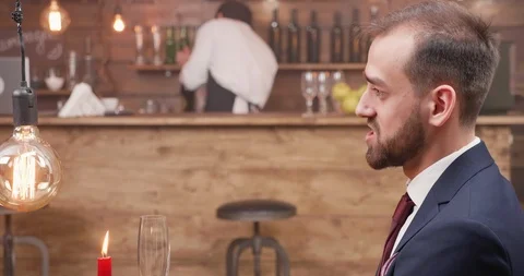 Young man having a conversation with his date Stock Footage 105057360