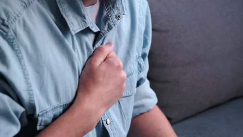 Young man having difficulty breathing pain heart, touches chest with hand Stock Footage 226153851