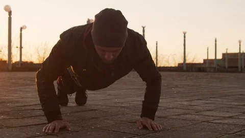 Young man having evening training outdoor. Urban sunset background. Fitness and Stock Footage 129651288