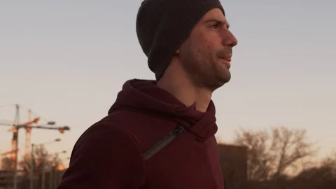 Young man having evening training outdoor. Urban sunset background. Fitness Stock Footage 129927993