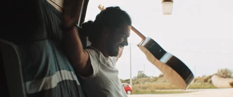 Young man having fun and playing the guitar Stock Footage 203584204