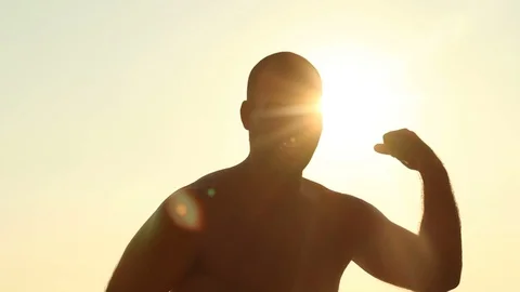 Young Man Having Fun On The Beach, Laughing And Showing Muscles Stock-Footage 99066688