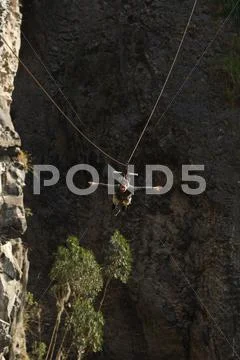 Young Man Having Fun During A Zip Line Flight In Banos De Agua Santa Ecuador Stock Photos