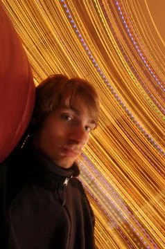 A young man having fun spinning in his chair. long exposure with a slow shutt Stock Photos