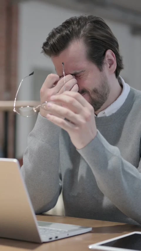 Young Man having Headache while Working on Laptop, Vertical Video Vidéo 339580602