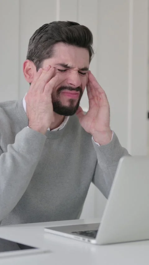Young Man having Headache while Working on Laptop, Vertical Video Stock Footage 339581885