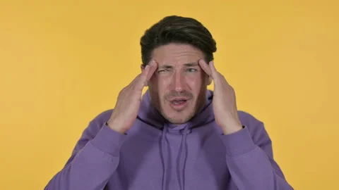 Young Man having Headache, Yellow Background 스톡 동영상 141681797