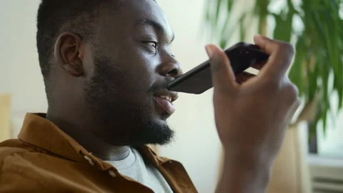 Young man having mobile call and holding smartphone in hand in home room. Stock Footage 158982134