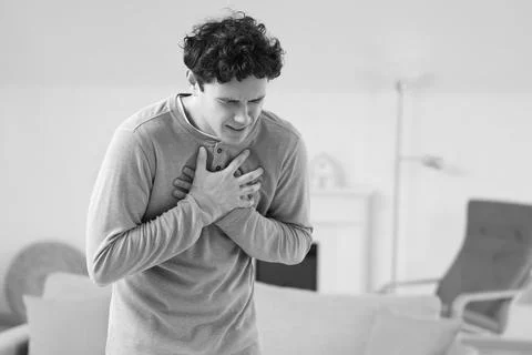 Young man having panic attack at home Stock Photos