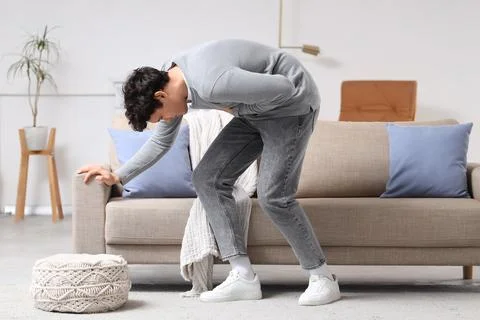 Young man having panic attack at home Stock Photos
