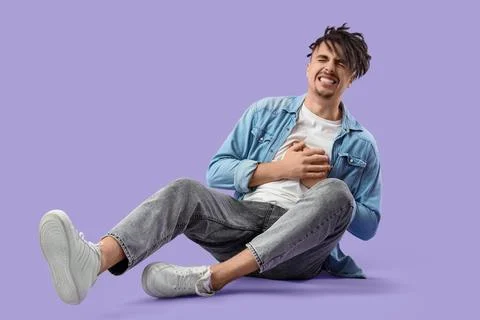 Young man having panic attack on lilac background Stock Photos
