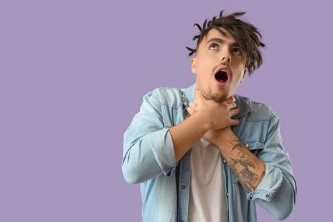 Young man having panic attack on lilac background Stock Photos