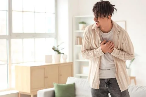 Young man having panic attack at home Stock Photos