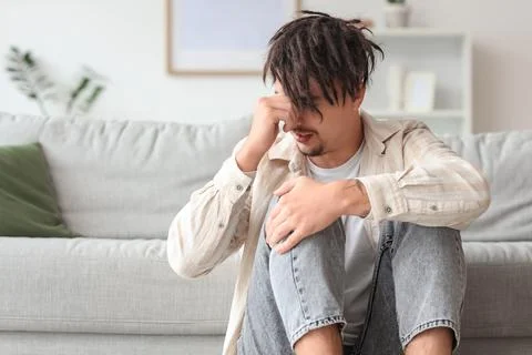 Young man having panic attack at home Stock Photos