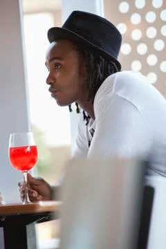 Young man having red wine at a bar Stock Photos