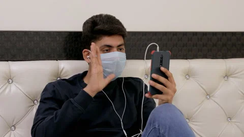 Young man having a video call via smartphone - distance communication concept Video stock 133223783