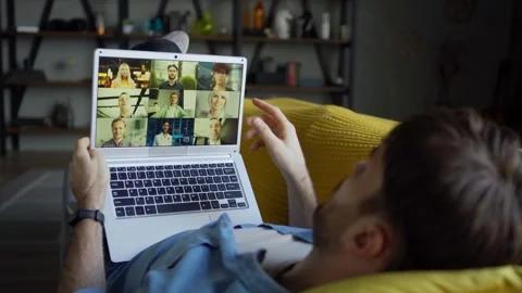 Young man having video call on laptop from home Stock Footage 148964171