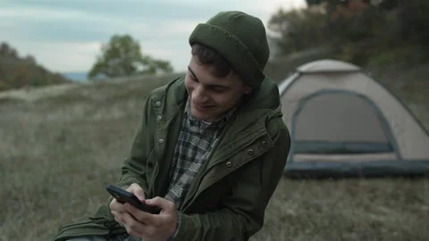 Young man having video call outdoors Stock Footage 319783477